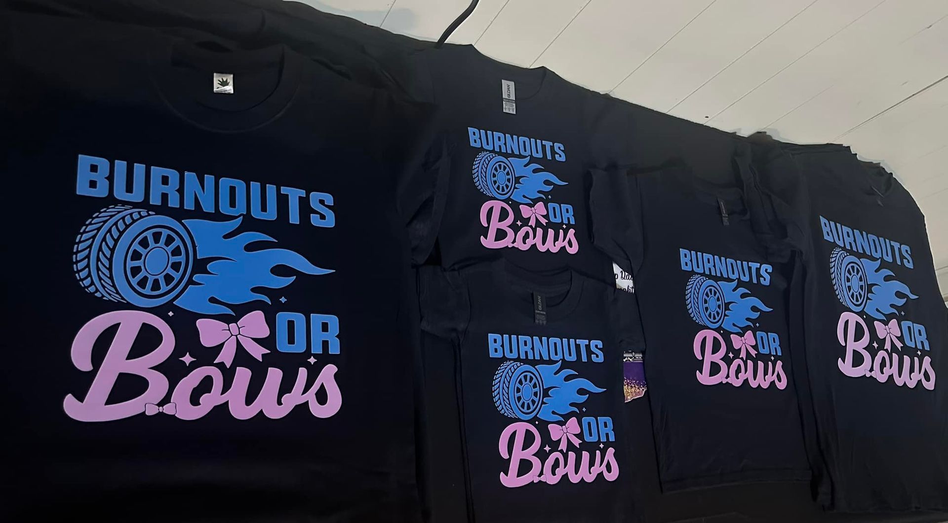 A bunch of burnouts for boys t-shirts sitting on a table