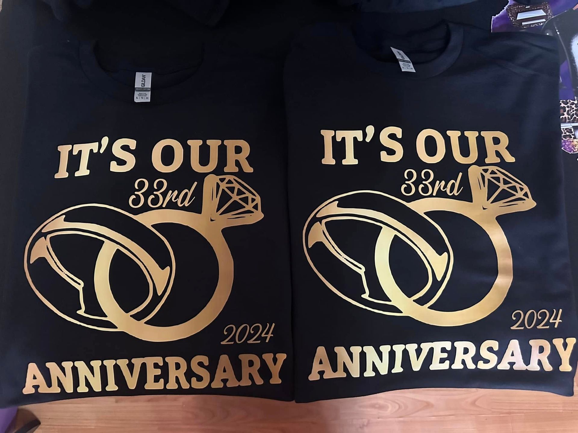 Two black shirts that say it 's our 38th anniversary