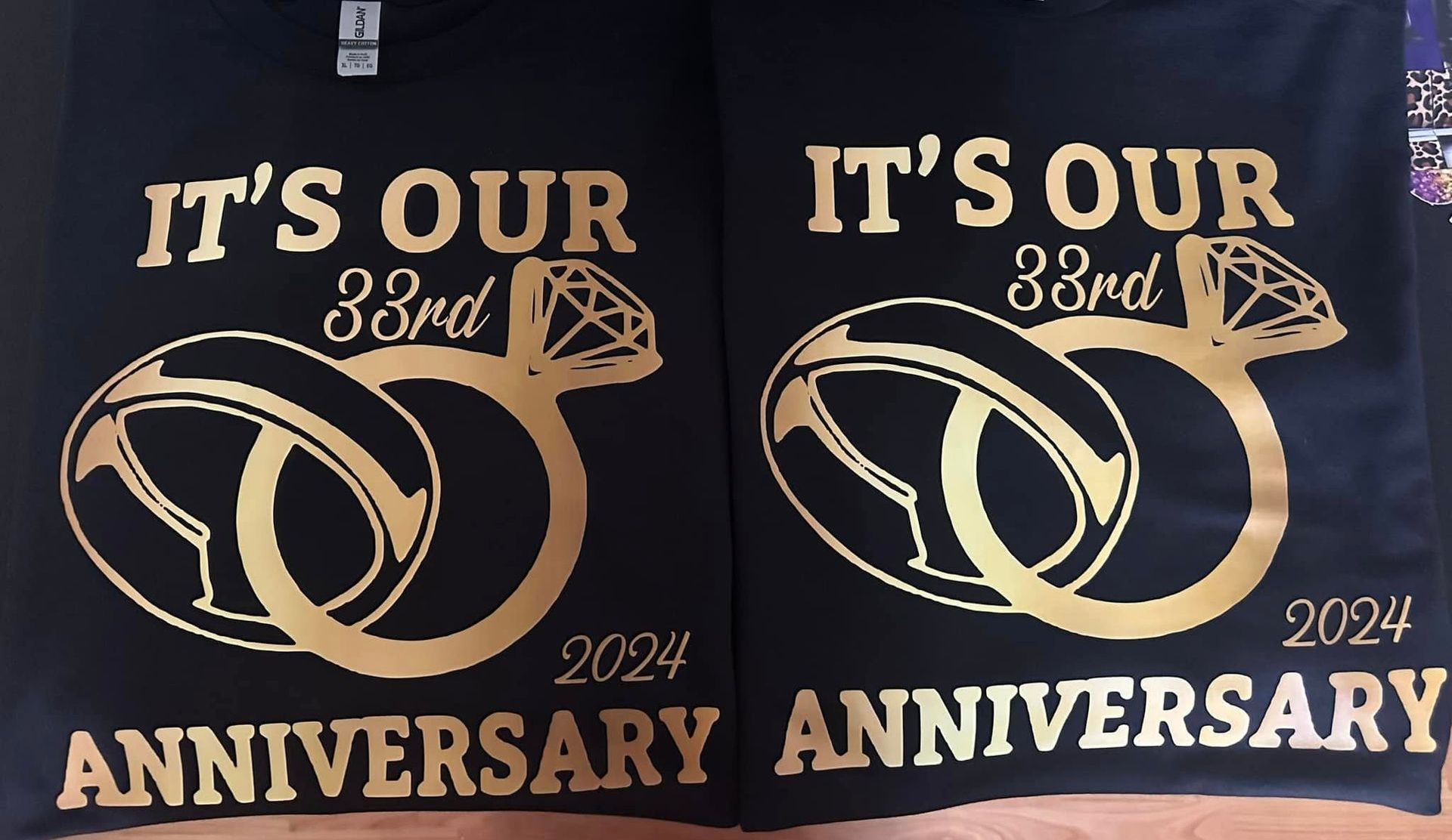 Two black shirts that say it 's our 33rd anniversary