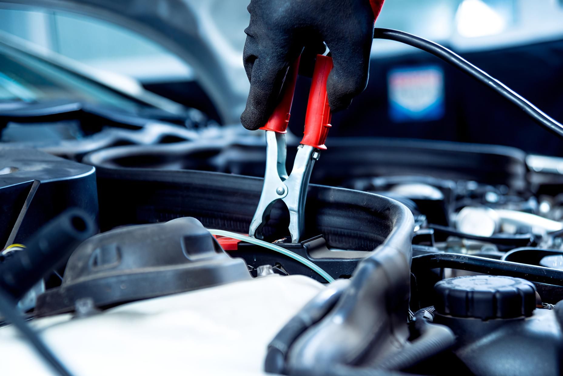 A Person is Charging a Car Battery With a Jump Starter — Cessnock Batteries In Maitland, NSW