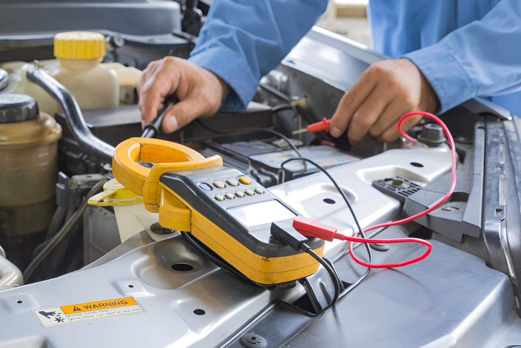 A Man is Working on a Car With a Voltmeter — Cessnock Batteries In Kurri Kurri, NSW