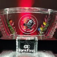 Clear glass trophy with red circular logo and BankFirst National sponsor text on black base.