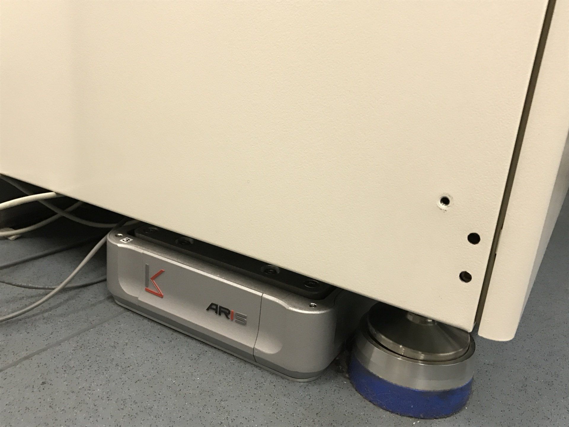 ARIS vibration isolation platform partially visible under laboratory equipment in a research setting