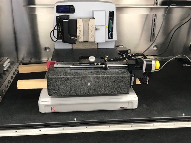 Precision instrument on a granite base mounted on an ARIS vibration isolation platform in a laboratory setting