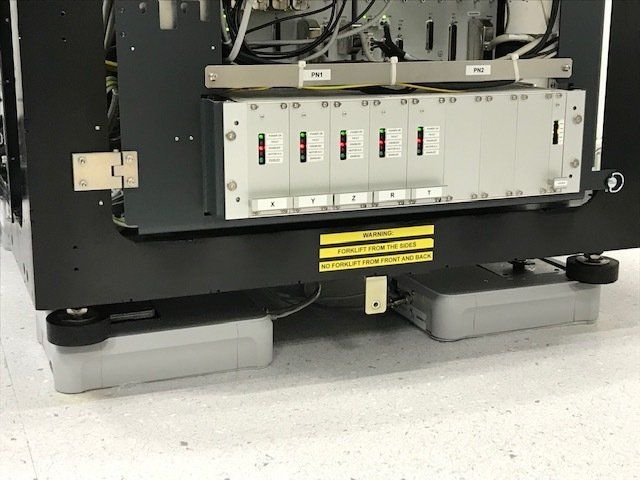 Laboratory equipment with control modules and warning labels mounted on vibration isolation platforms