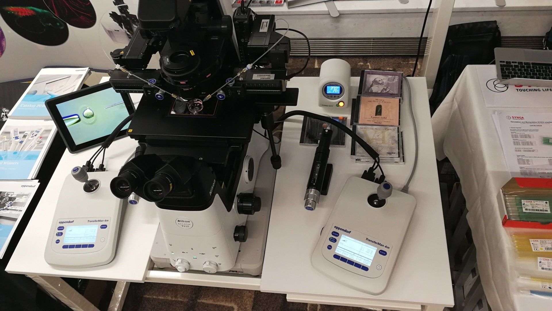Advanced lab microscope with connected control panels, cameras equipment displayed on a workstation for precision research
