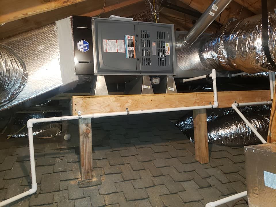 A room with a lot of pipes and a box on top of it.