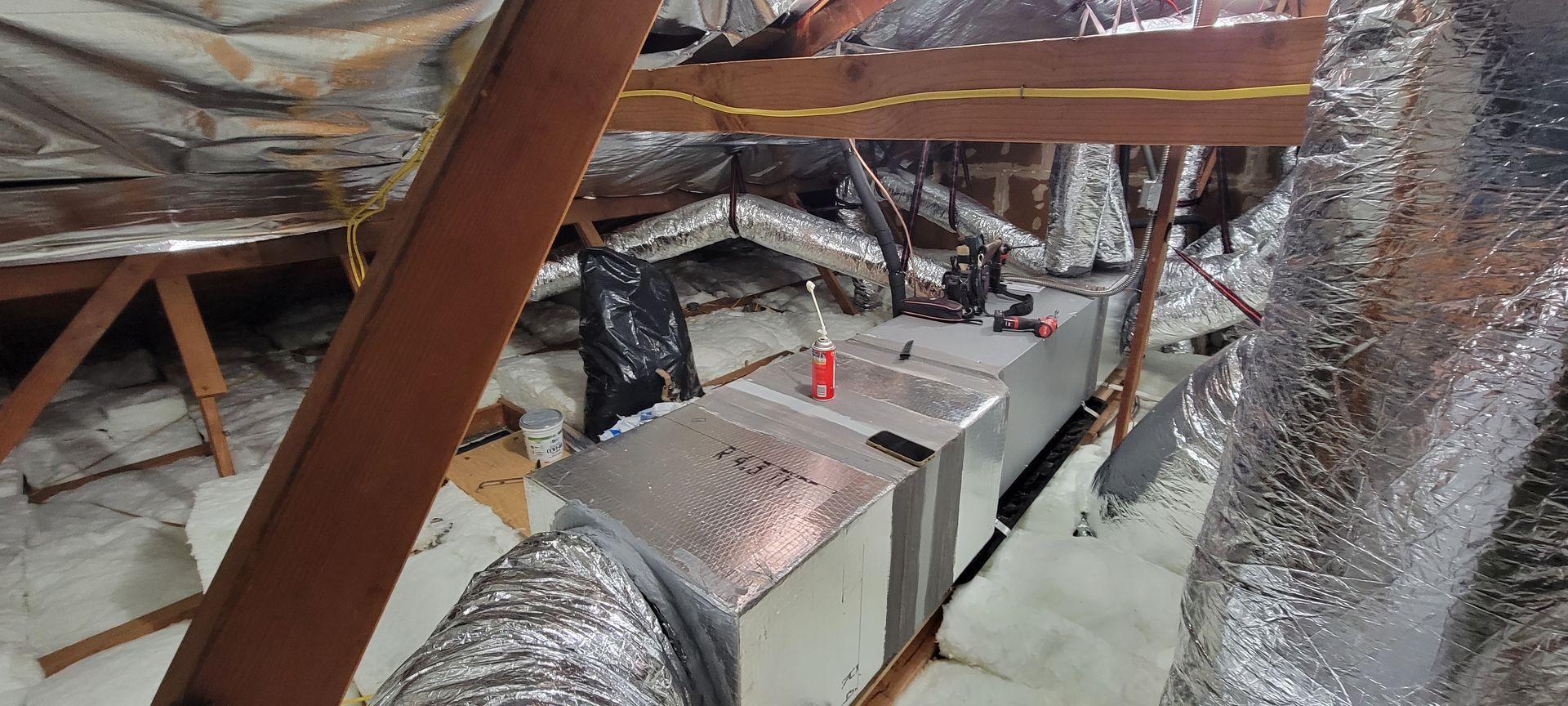 There is a lot of aluminum foil on the floor in the attic.