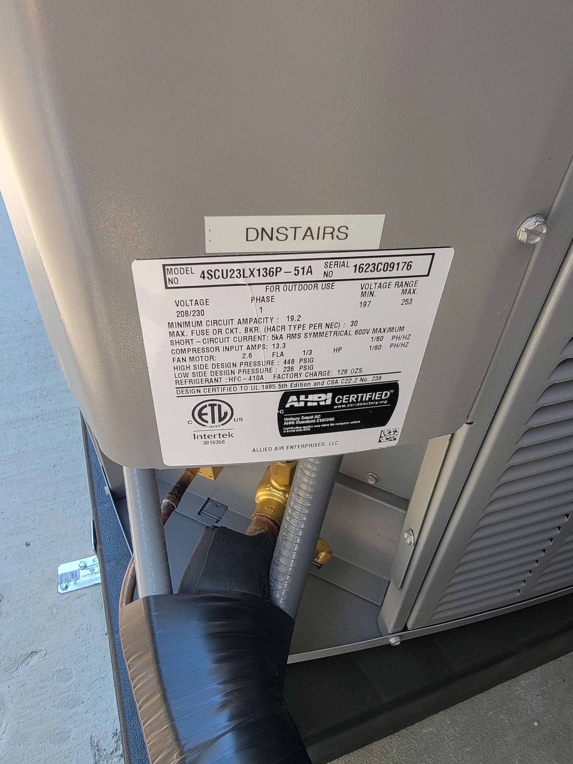 A stainless steel tank with a label on it that says contains