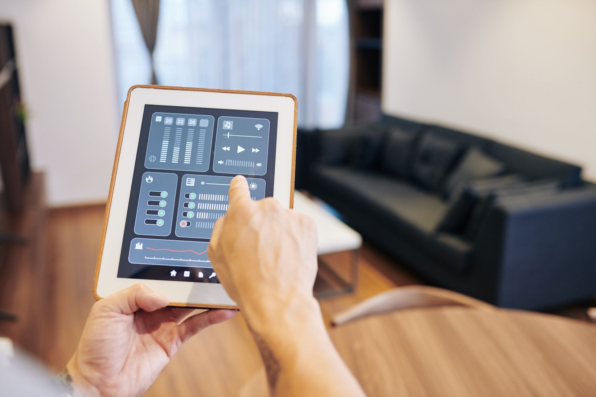 A person is using a tablet in a living room.