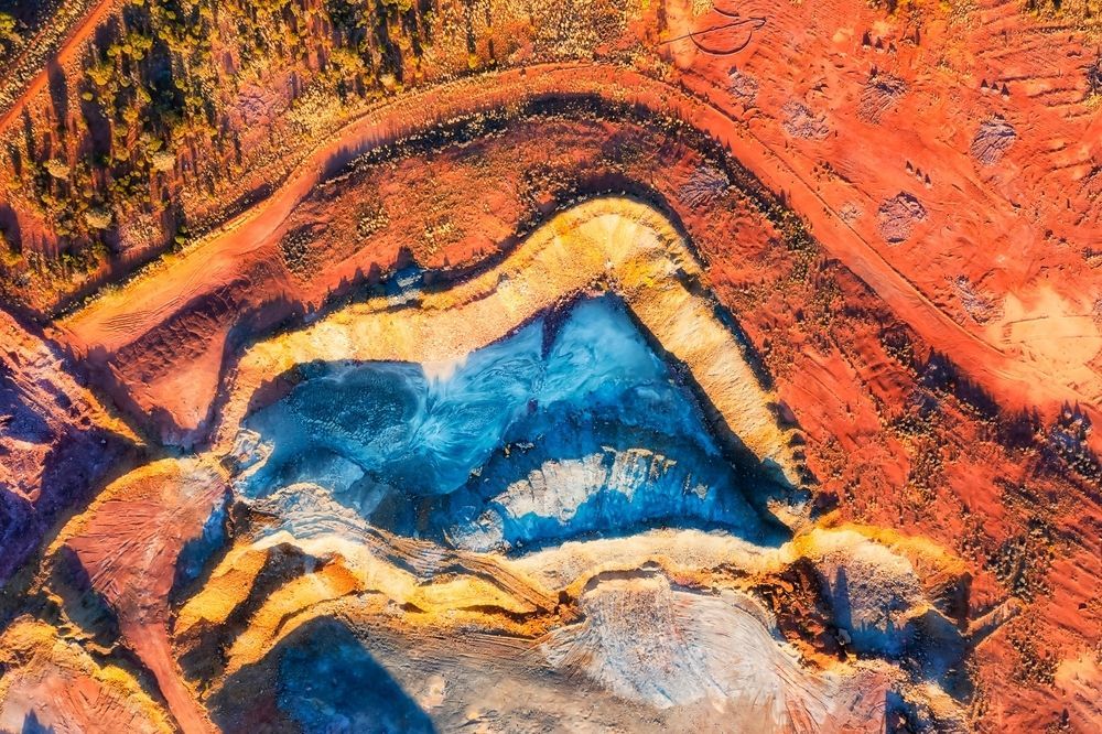 Aerial View of a Colourful Canyon With Layers of Red, Orange, Yellow, and Blue Earth — Boland Contracting in Cobar, NSW