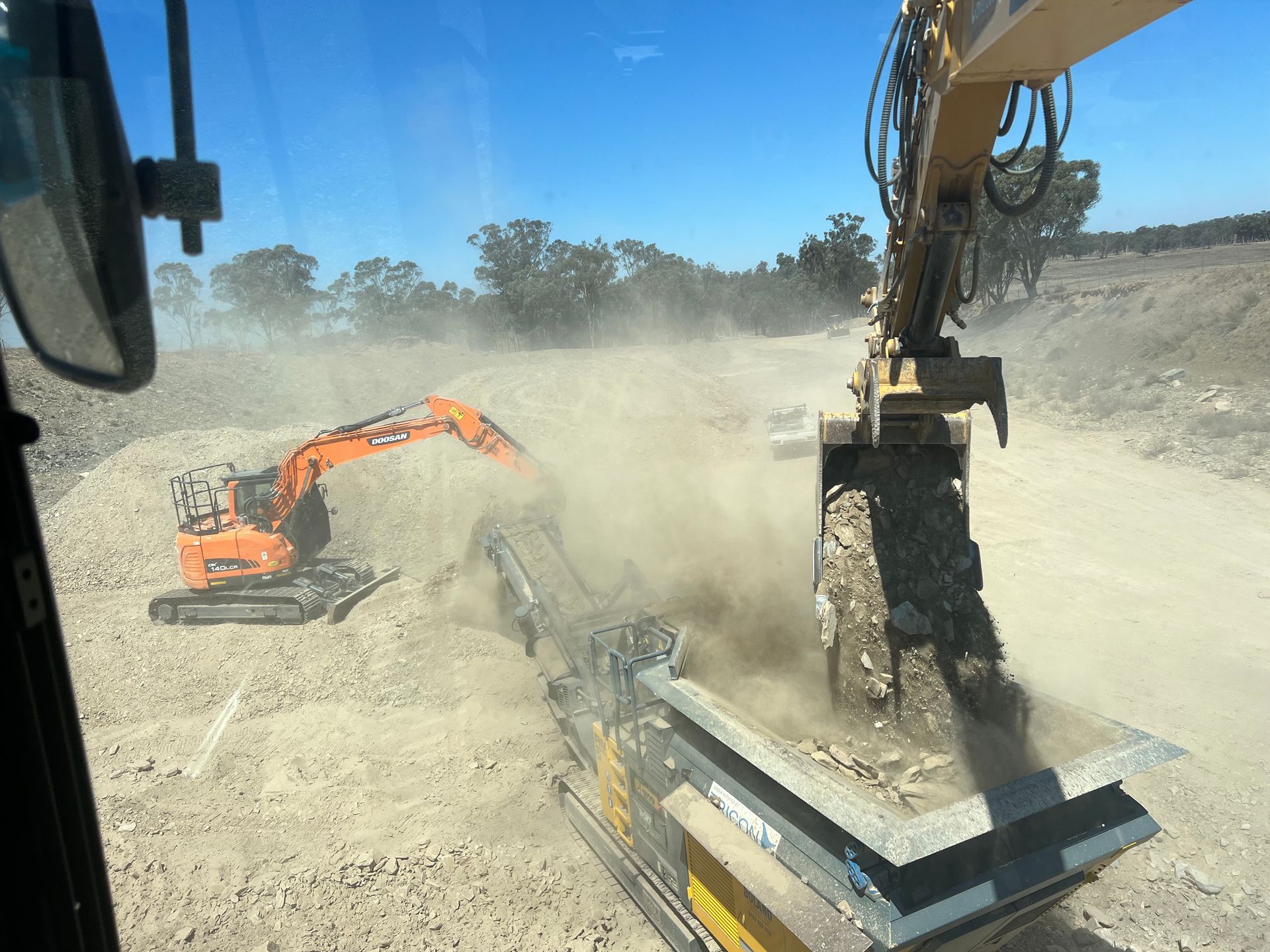 Construction Site Excavator and Crusher in Action, Creating Dust — Boland Contracting In Wellington, NSW