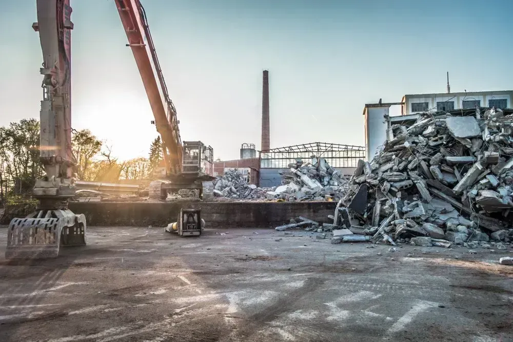 Demolition Site With Excavator Dismantling a Building — Boland Contracting In Wellington, NSW