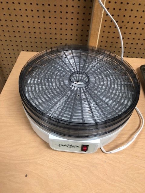 A dehydrator is sitting on a wooden table
