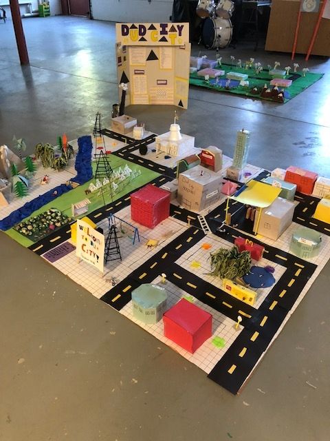 A model of a city with roads and buildings made out of cardboard