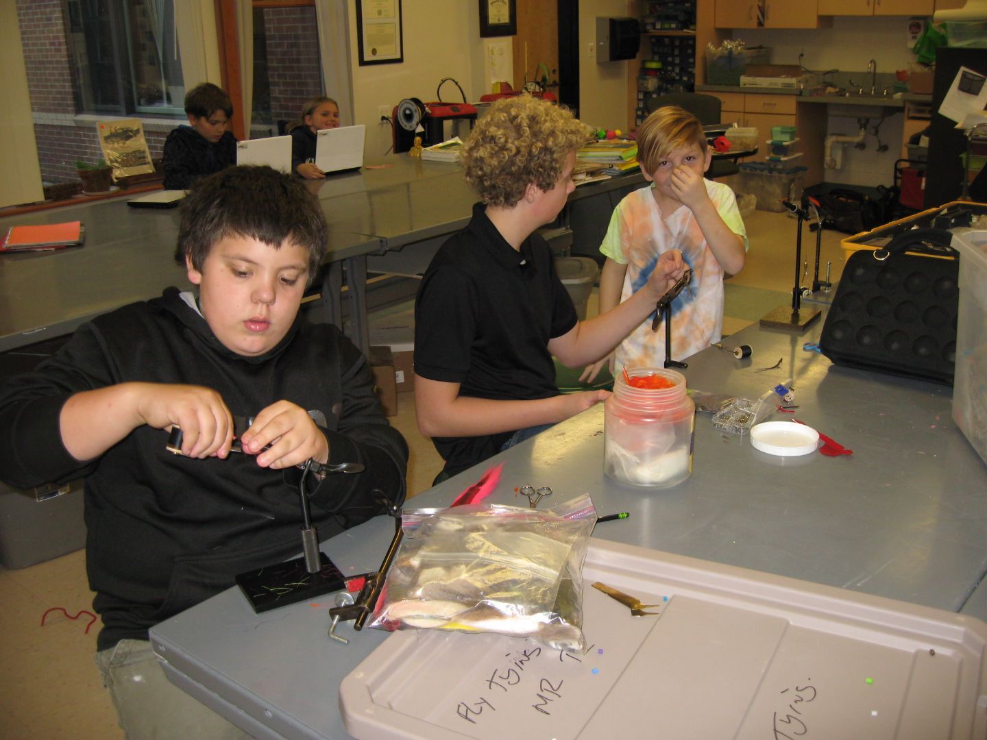 A group of young boys are working on a project in a lab