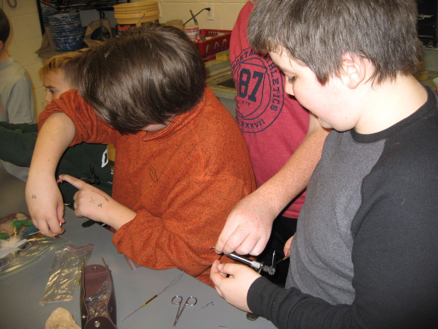 A boy wearing a red shirt with the number 82 on it