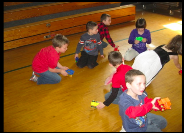 A group of children are playing with toys on the floor