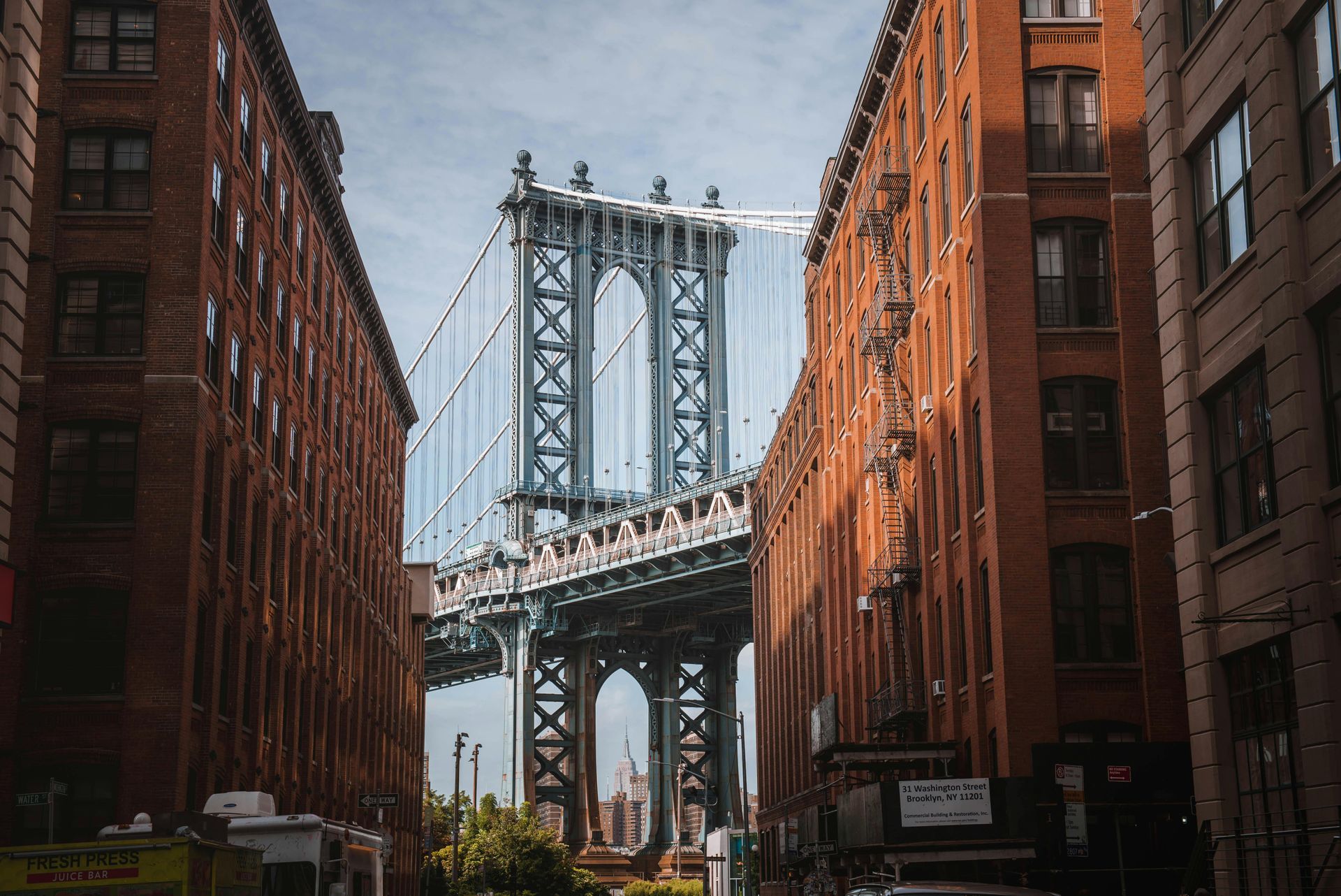 A bridge is between two buildings in a city.