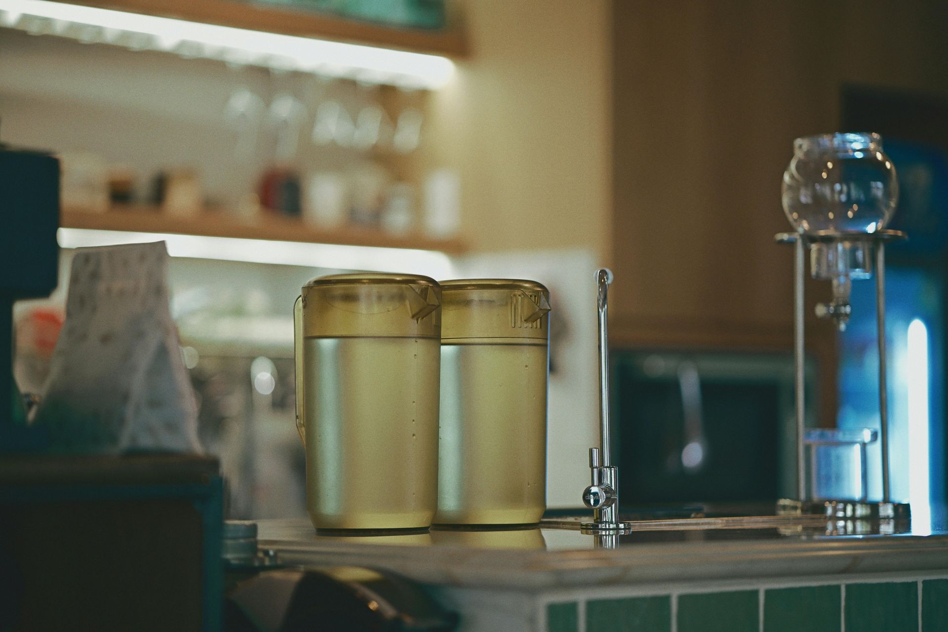 A man is working on a solar water heater on a roof.