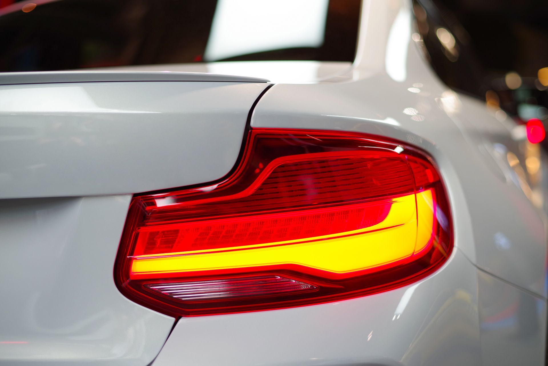 A close up of a white car 's tail light.