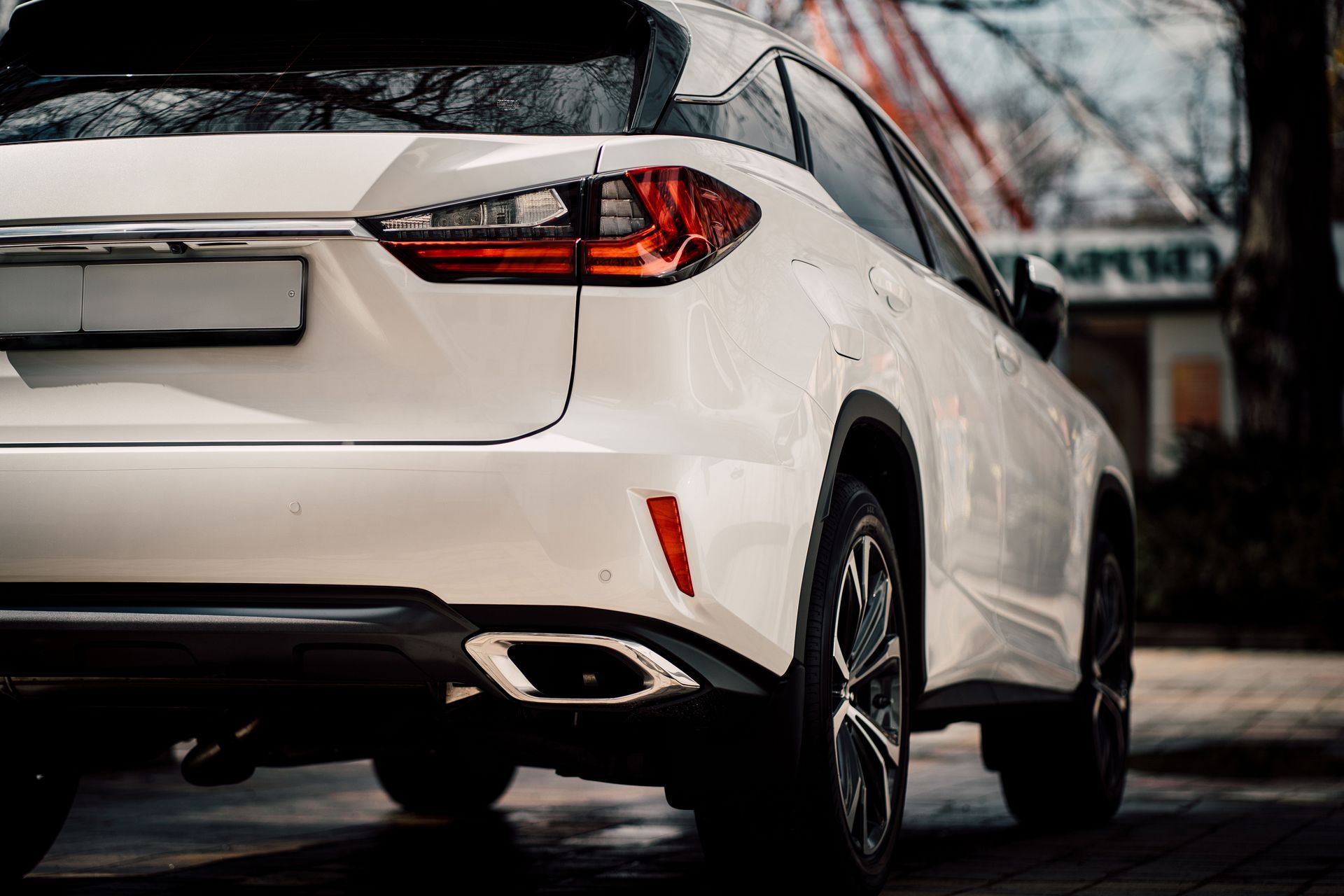 A white car is parked on the side of the road.