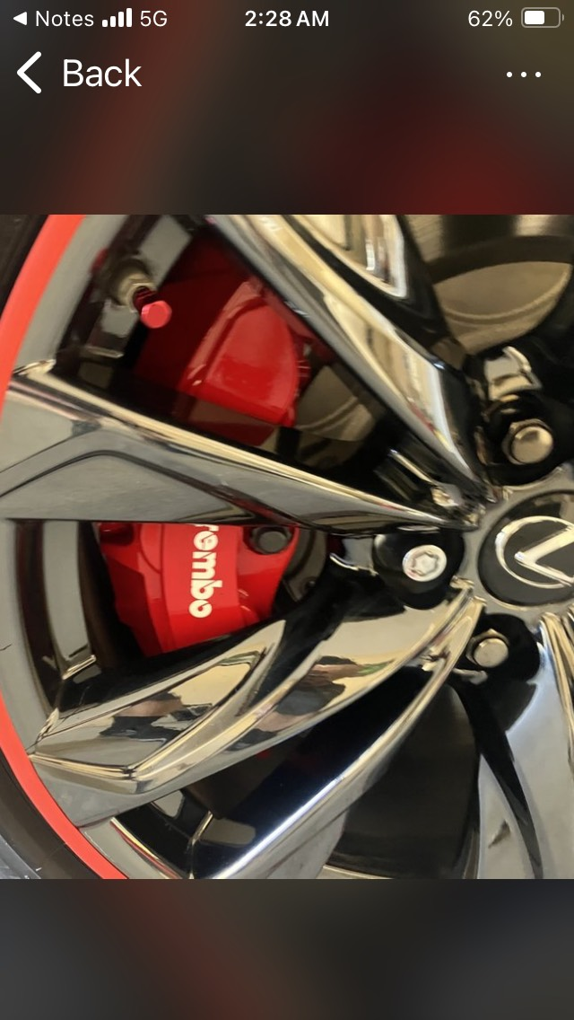 A close up of a brembo brake on a car wheel