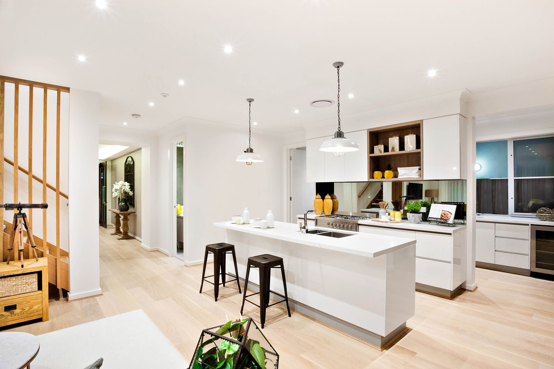 Modern Kitchen With White Walls Illuminated By Hanging Lamps - Lakewood, CA - Wise Floor Pros 