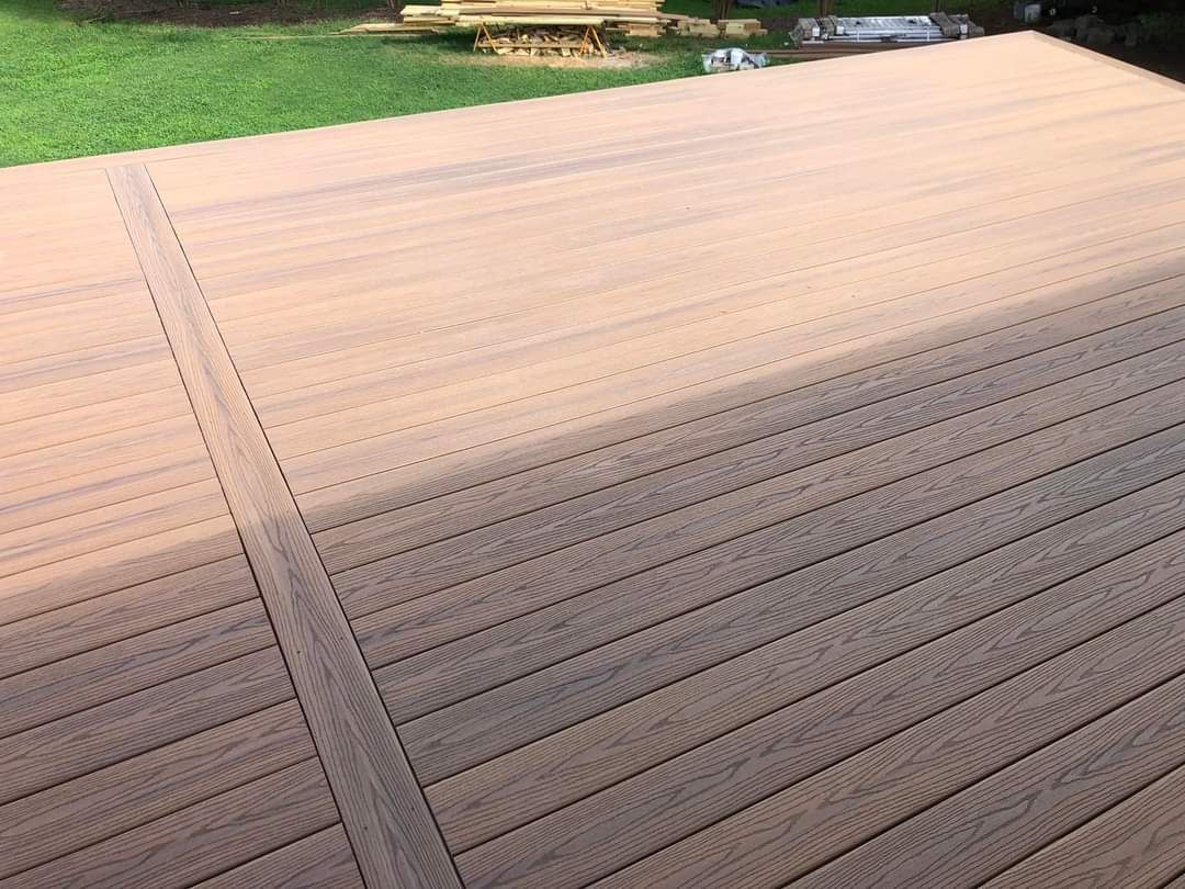 A person holding a baby up in the air indoors near a window, baby smiling.