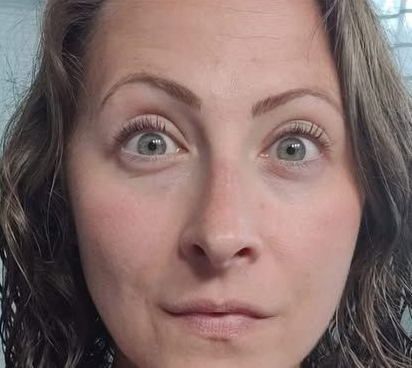 Woman with light skin, wide eyes, and neutral expression.