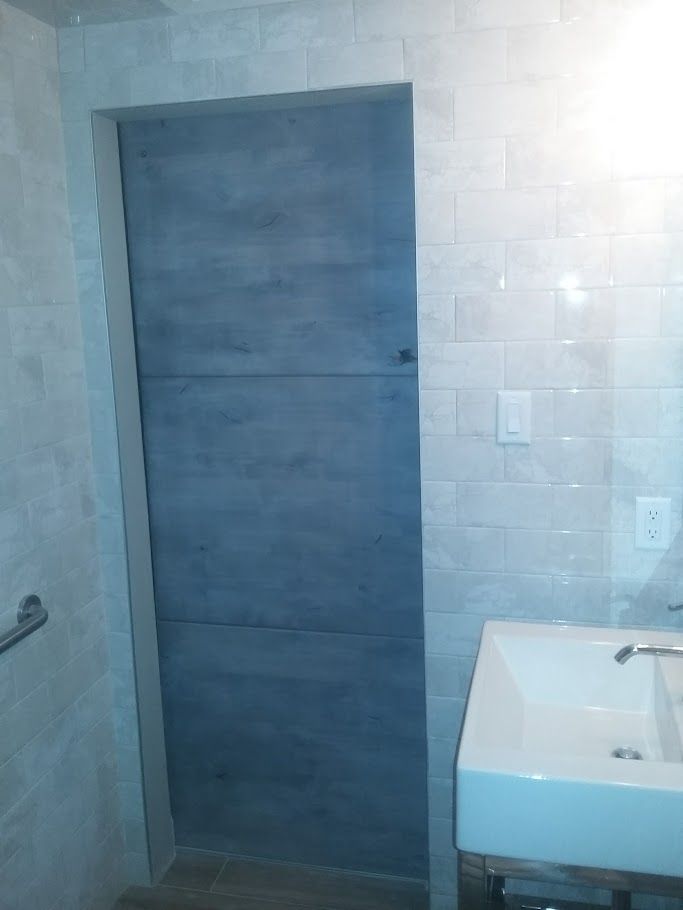 A bathroom with a sink and a door.