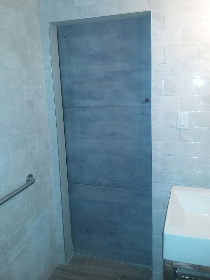 A bathroom with a sink and a blue door