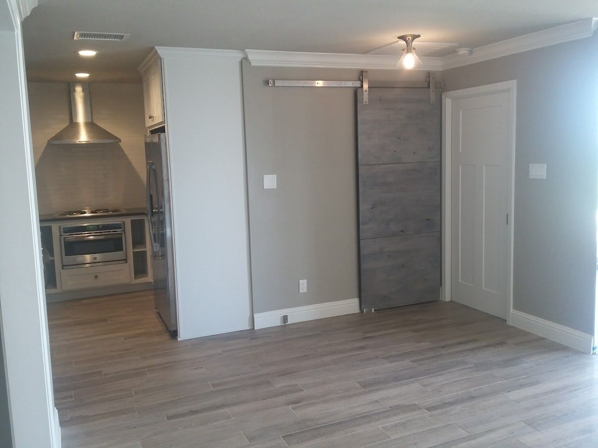 An empty kitchen with a sliding barn door