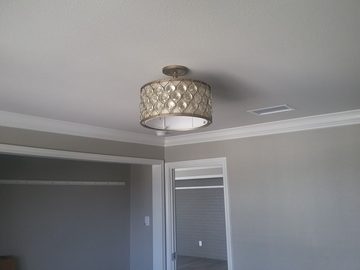 A light fixture is hanging from the ceiling in a room
