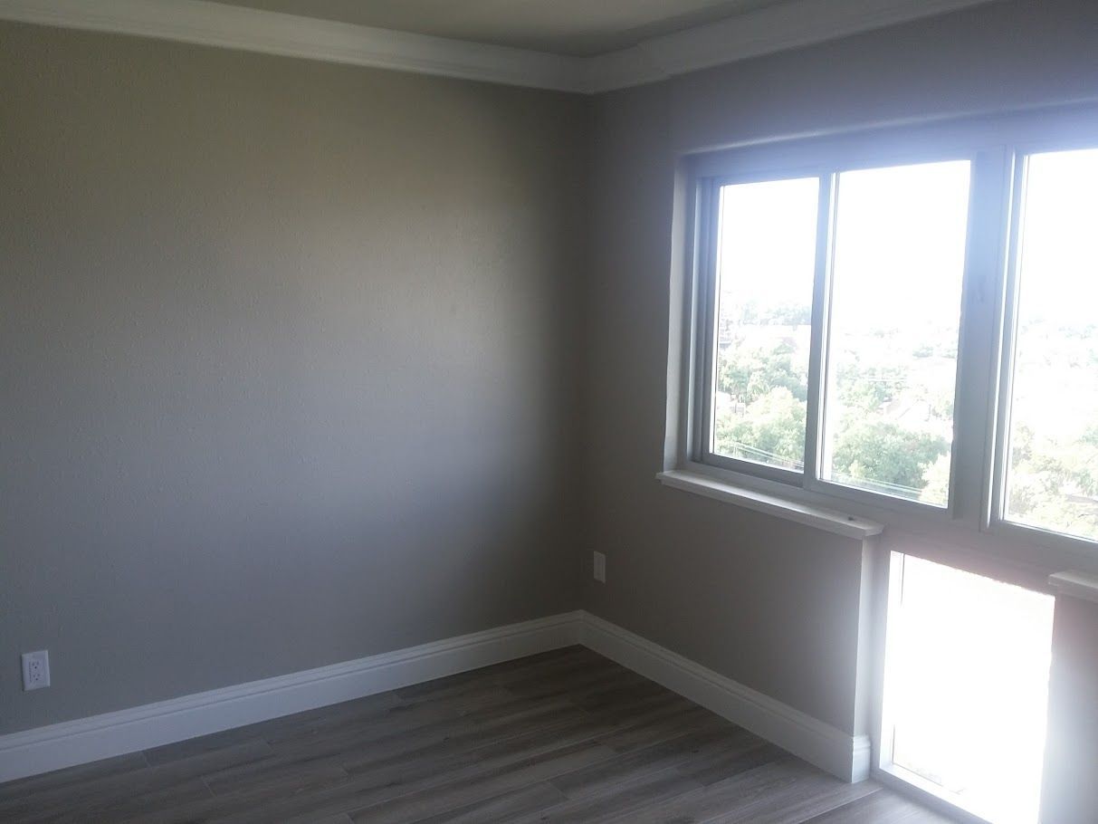 An empty room with a window and a door