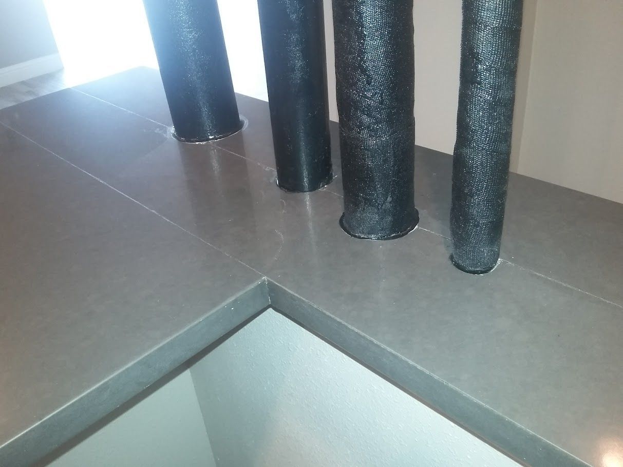 Three black cylinders are sitting on a counter top