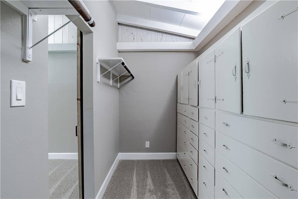 A walk in closet with lots of drawers and cabinets