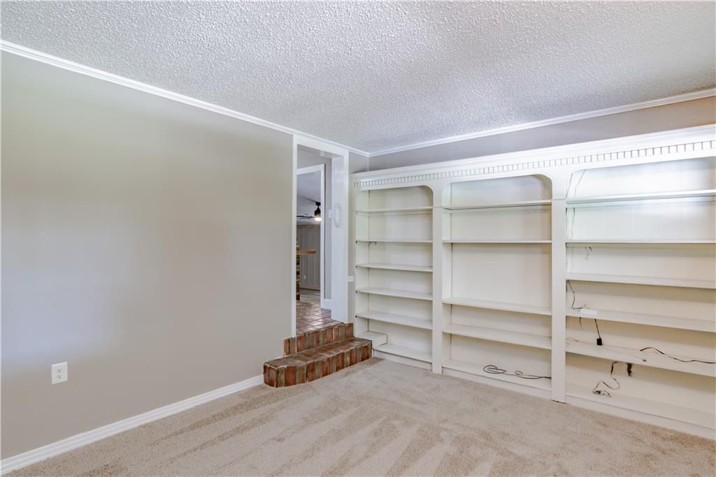 An empty room with a lot of shelves and stairs.