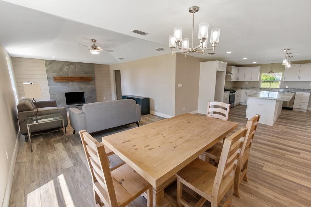 There is a dining table and chairs in the middle of the room.