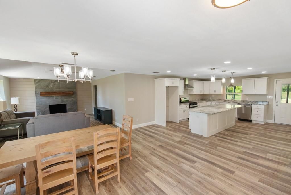 There is a table and chairs in the middle of the room.