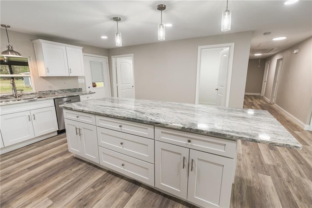 There is a large island in the middle of the kitchen.