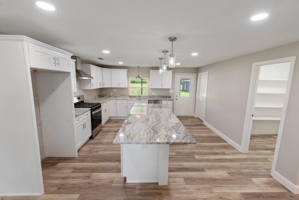 There is a large island in the middle of the kitchen.