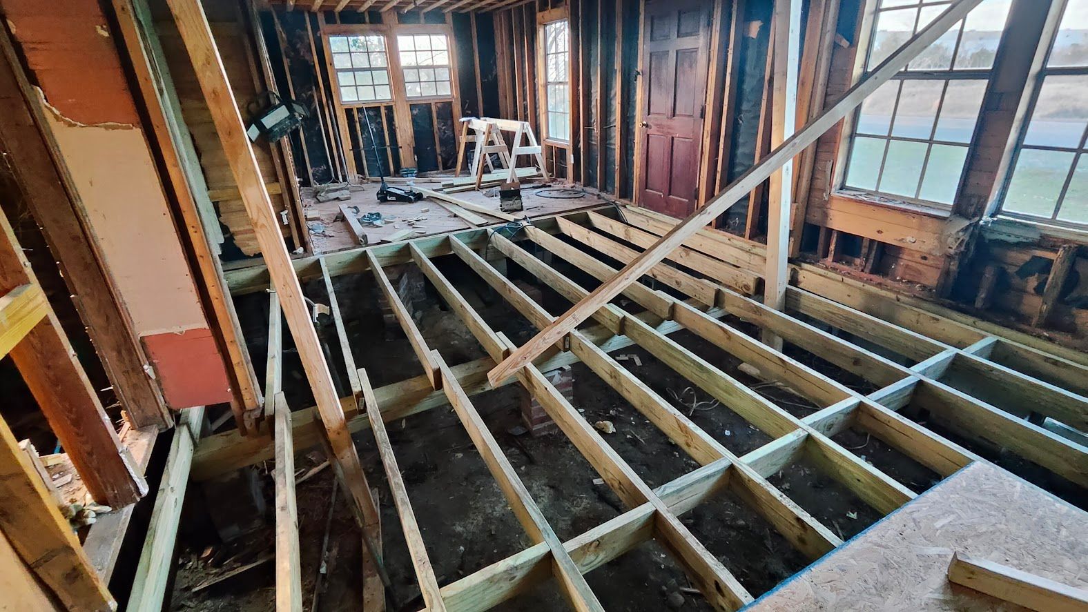 A wooden floor is being built in a house under construction.