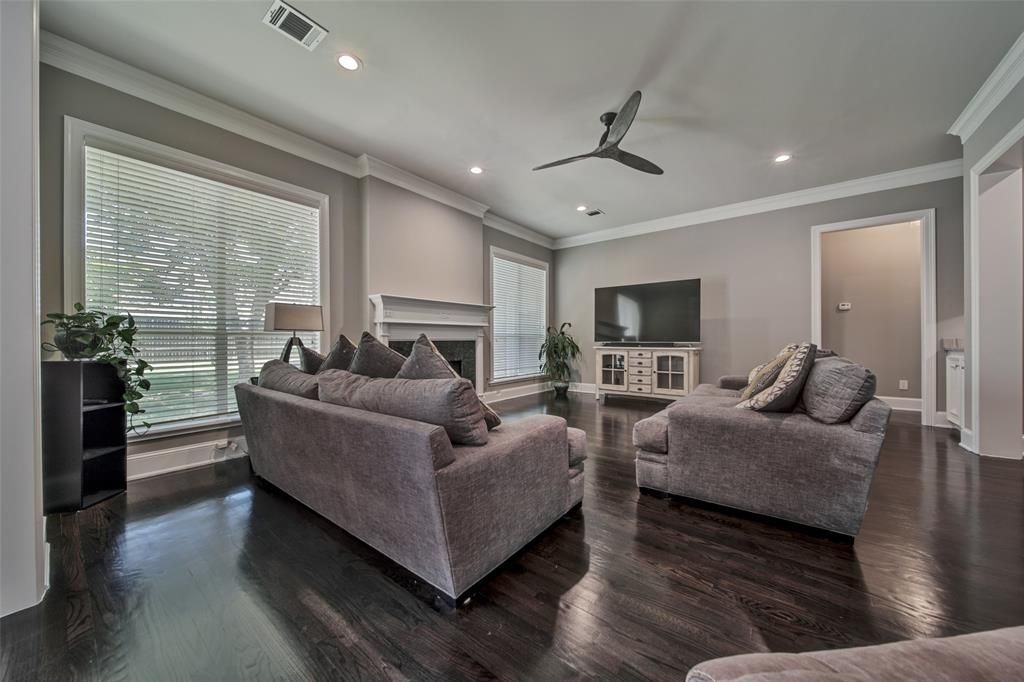 A living room filled with furniture and a ceiling fan.