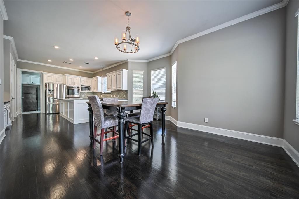 There is a dining room table and chairs in the middle of the room.