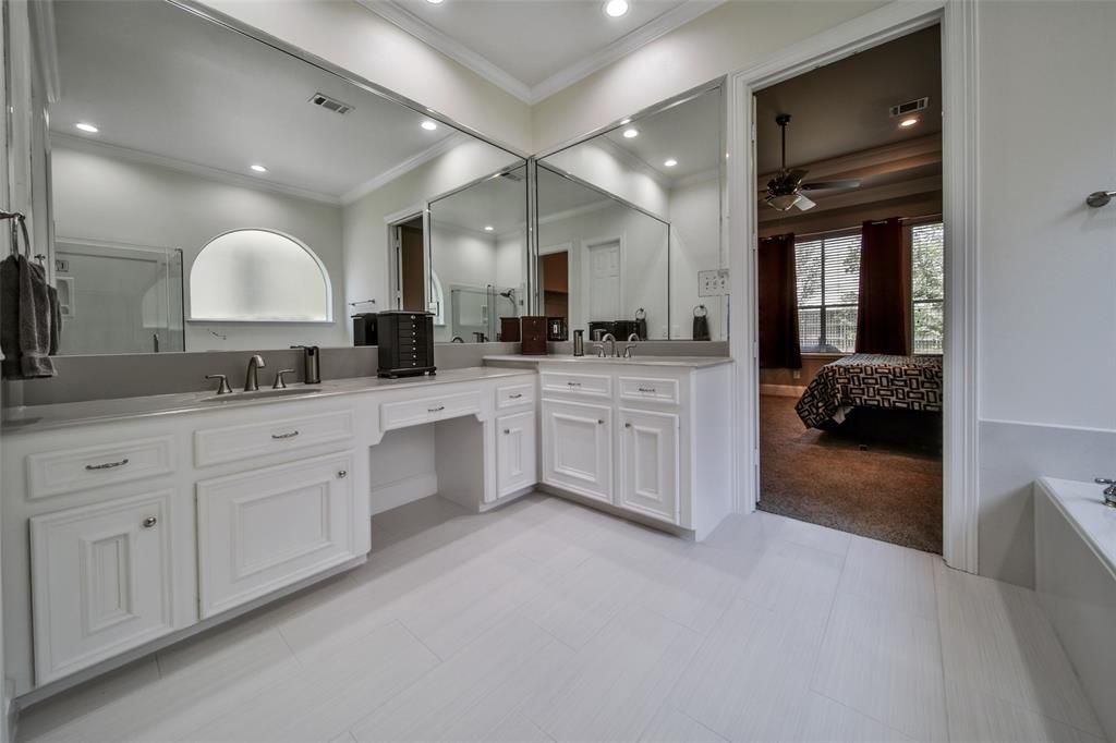 A bathroom with two sinks and a large mirror