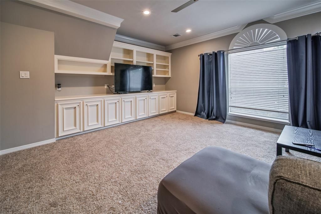 A living room with a couch and a television.