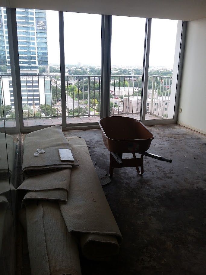 An empty room with a wheelbarrow in the middle of it