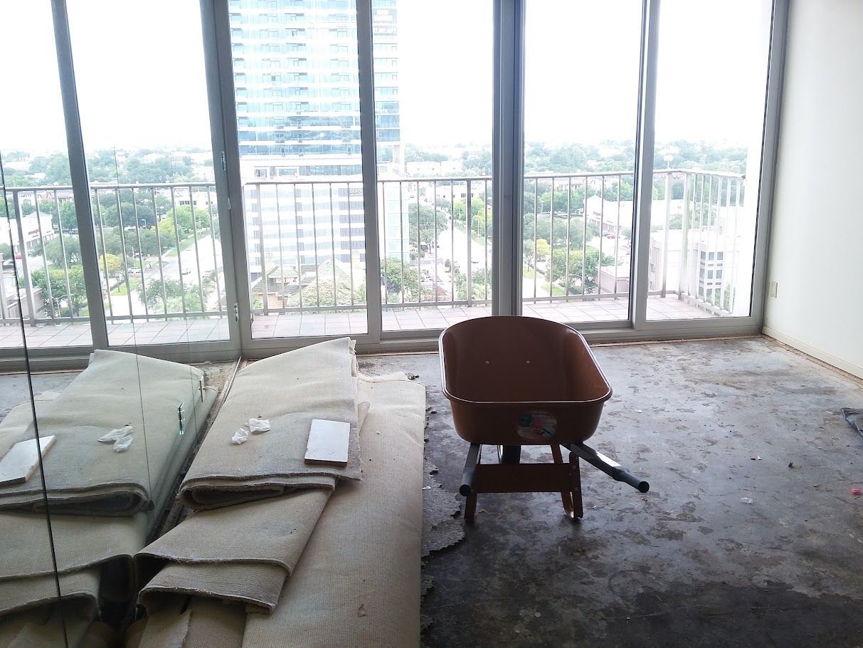 An empty room with a wheelbarrow in the middle of it