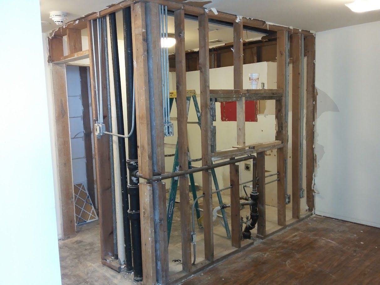 A room with a wooden wall and a ladder in it